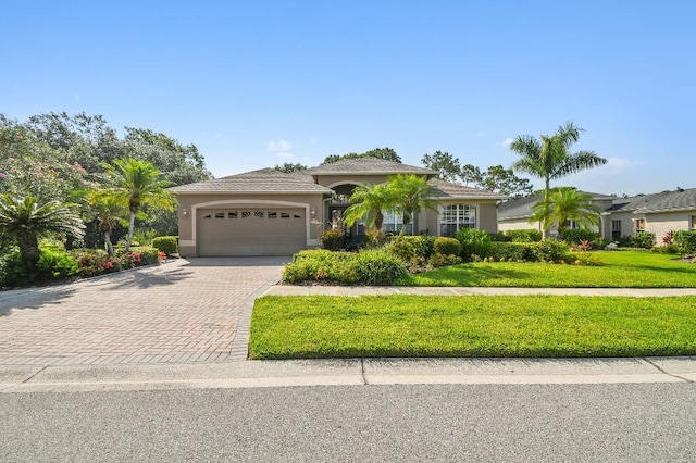 3402 Stonebridge Trl, Valrico, FL 33596 - view of front of property with decorative driveway, a garage, stucco siding, and a front yard