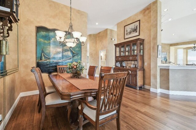 3402 Stonebridge Trl, Valrico, FL 33596 - dining space featuring wood finished floors, a chandelier, baseboards, and recessed lighting