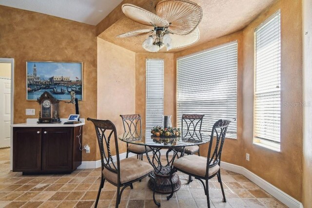 3402 Stonebridge Trl, Valrico, FL 33596 - dining room featuring a ceiling fan, baseboards, and stone tile flooring