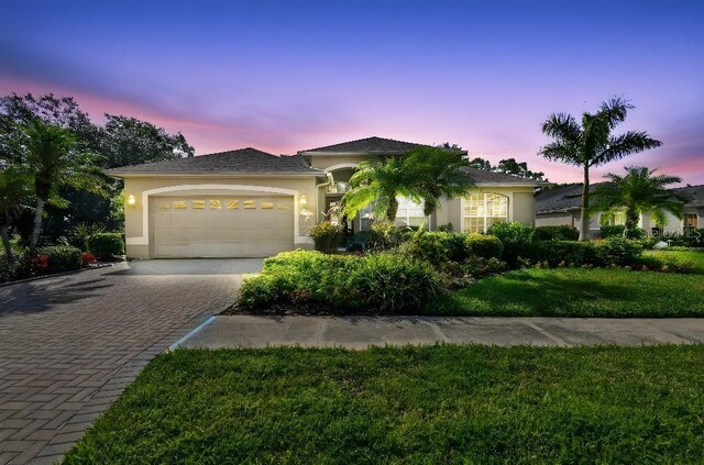 3402 Stonebridge Trl, Valrico, FL 33596 - view of front facade featuring stucco siding, a garage, decorative driveway, and a front yard