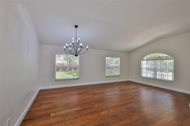 11726 S Stone Ln, Riverview, FL 33569 - spare room with lofted ceiling, dark wood finished floors, a chandelier, and baseboards