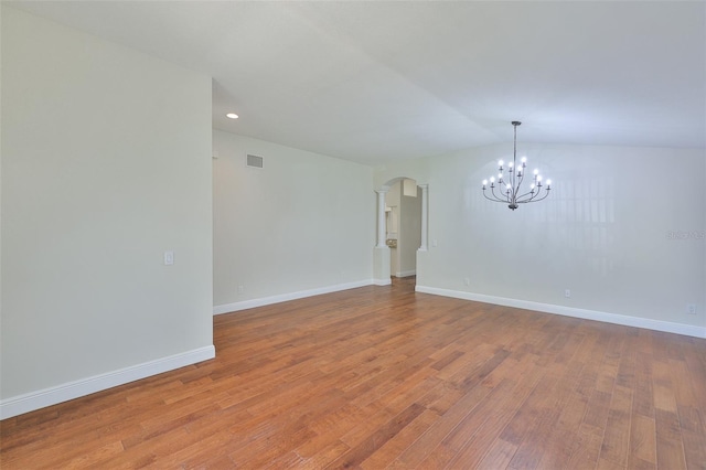 11726 S Stone Ln, Riverview, FL 33569 - empty room featuring arched walkways, a chandelier, wood finished floors, baseboards, and recessed lighting