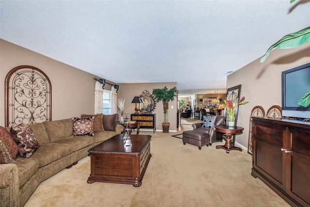 100 Bluff View Dr Unit 514C, Belleair Bluffs, FL 33770 - living area featuring carpet, a textured ceiling, a chandelier, and baseboards