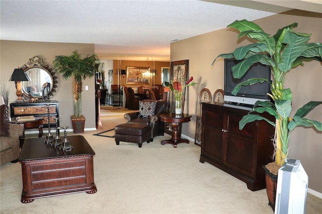 100 Bluff View Dr Unit 514C, Belleair Bluffs, FL 33770 - living room featuring a chandelier, carpet, and baseboards