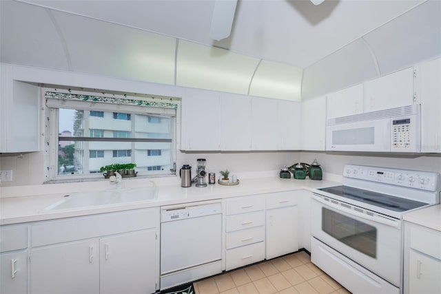 100 Bluff View Dr Unit 514C, Belleair Bluffs, FL 33770 - kitchen featuring white appliances, a sink, light countertops, white cabinetry, and light tile patterned floors