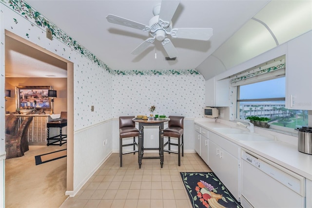 100 Bluff View Dr Unit 514C, Belleair Bluffs, FL 33770 - kitchen with white dishwasher, wallpapered walls, a sink, light countertops, and white cabinets