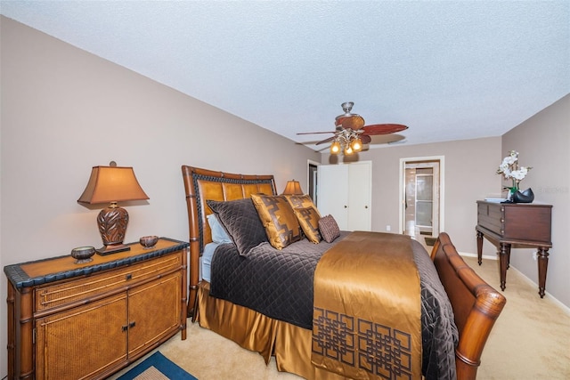 100 Bluff View Dr Unit 514C, Belleair Bluffs, FL 33770 - bedroom with light colored carpet, a textured ceiling, ensuite bath, a ceiling fan, and baseboards