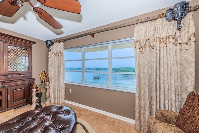 100 Bluff View Dr Unit 514C, Belleair Bluffs, FL 33770 - living area with baseboards and a ceiling fan