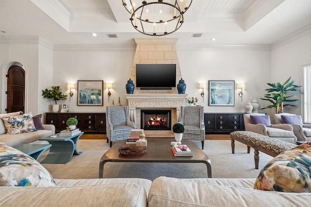 301 Bayview Dr NE, Saint Petersburg, FL 33704 - living room with a chandelier, a tile fireplace, crown molding, a tray ceiling, and recessed lighting