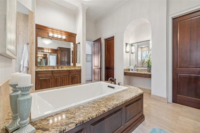 301 Bayview Dr NE, Saint Petersburg, FL 33704 - bathroom with a bath, vanity, and ornamental molding