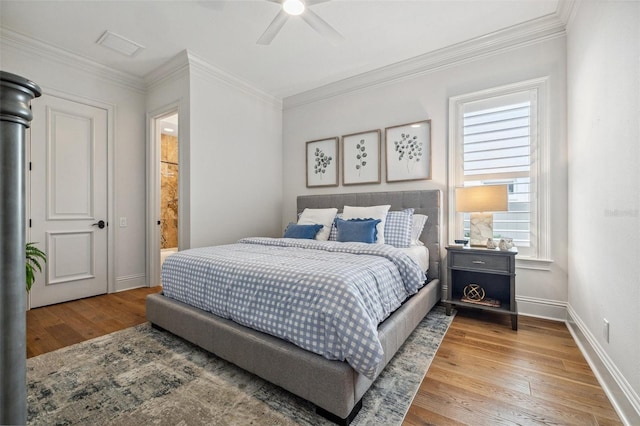 301 Bayview Dr NE, Saint Petersburg, FL 33704 - bedroom featuring wood finished floors, crown molding, baseboards, and ceiling fan
