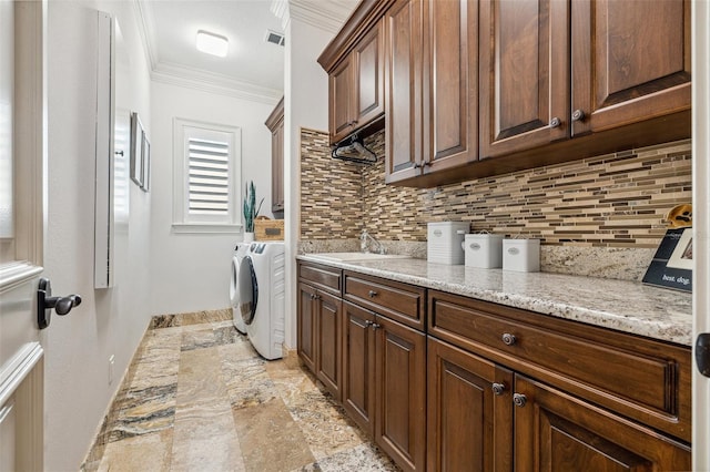 301 Bayview Dr NE, Saint Petersburg, FL 33704 - washroom with cabinet space, ornamental molding, washer and dryer, and baseboards
