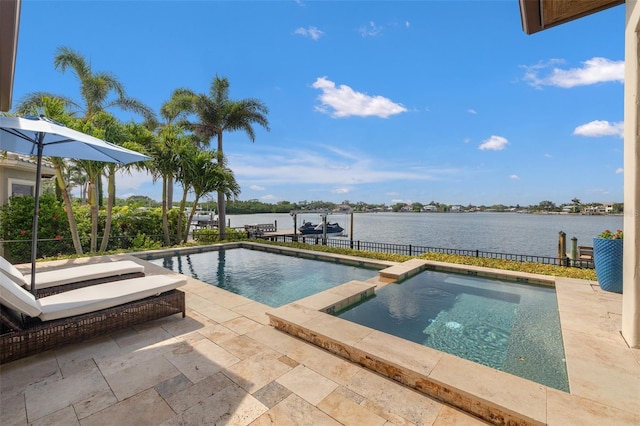 301 Bayview Dr NE, Saint Petersburg, FL 33704 - view of swimming pool featuring a water view, a patio area, and a pool with connected hot tub