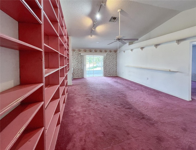 502 Chilt Dr, Brandon, FL 33510 - unfurnished living room with carpet flooring, ceiling fan, track lighting, vaulted ceiling, and wallpapered walls