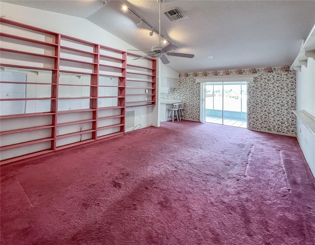 502 Chilt Dr, Brandon, FL 33510 - unfurnished living room featuring wallpapered walls, a textured ceiling, carpet floors, track lighting, and lofted ceiling