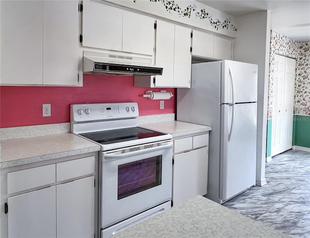 502 Chilt Dr, Brandon, FL 33510 - kitchen with white appliances, under cabinet range hood, light countertops, white cabinets, and wallpapered walls