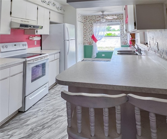 502 Chilt Dr, Brandon, FL 33510 - kitchen with electric range, a sink, under cabinet range hood, white cabinetry, and a ceiling fan