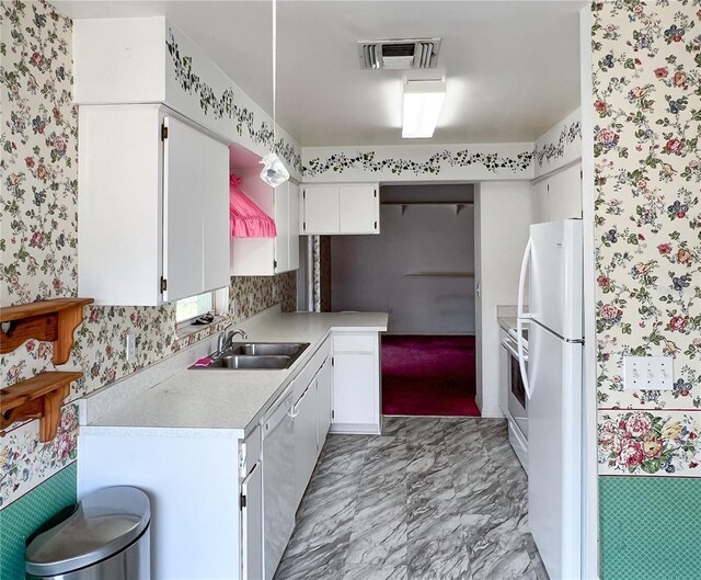 502 Chilt Dr, Brandon, FL 33510 - kitchen featuring wallpapered walls, a sink, white appliances, light countertops, and white cabinets