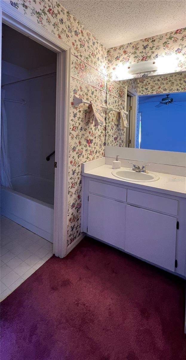 502 Chilt Dr, Brandon, FL 33510 - full bathroom with wallpapered walls, vanity, a textured ceiling, and baseboards