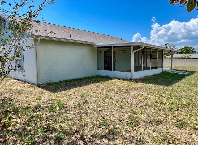 502 Chilt Dr, Brandon, FL 33510 - rear view of house with a sunroom, a lawn, and stucco siding