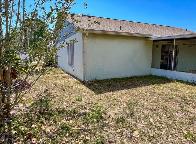 502 Chilt Dr, Brandon, FL 33510 - view of home's exterior featuring stucco siding, a shingled roof, and a yard