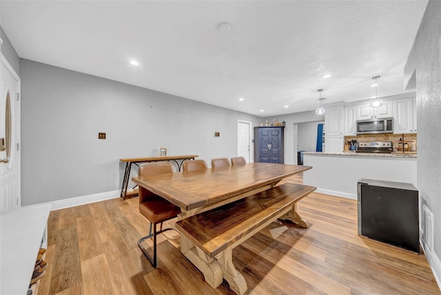 4726 W Fairview Hts, Tampa, FL 33616 - dining area with light wood finished floors, recessed lighting, and baseboards