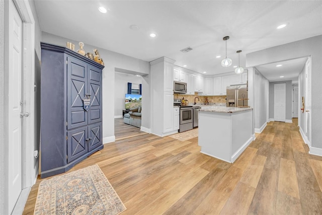 4726 W Fairview Hts, Tampa, FL 33616 - kitchen with appliances with stainless steel finishes, white cabinetry, light wood-type flooring, hanging light fixtures, and recessed lighting