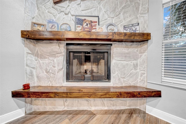 4726 W Fairview Hts, Tampa, FL 33616 - detailed view of baseboards, wood finished floors, and a fireplace with raised hearth