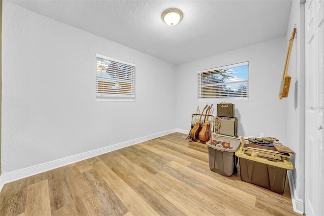 4726 W Fairview Hts, Tampa, FL 33616 - office area featuring light wood-style floors, a textured ceiling, and baseboards