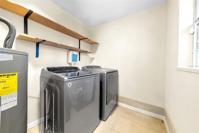 4726 W Fairview Hts, Tampa, FL 33616 - laundry area featuring electric water heater, washer and dryer, baseboards, and light tile patterned floors
