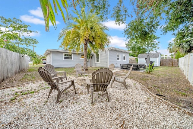 4726 W Fairview Hts, Tampa, FL 33616 - rear view of house with a fire pit and a fenced backyard