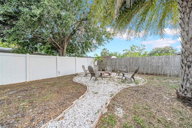 4726 W Fairview Hts, Tampa, FL 33616 - fenced backyard with an outdoor fire pit