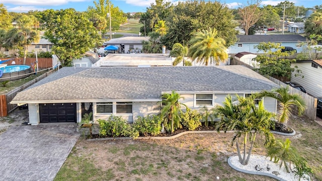 4726 W Fairview Hts, Tampa, FL 33616 - view of property hidden behind natural elements with roof with shingles, driveway, and a garage