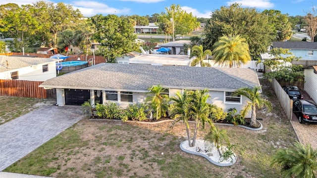 4726 W Fairview Hts, Tampa, FL 33616 - view of front of property featuring driveway, a shingled roof, and an attached garage