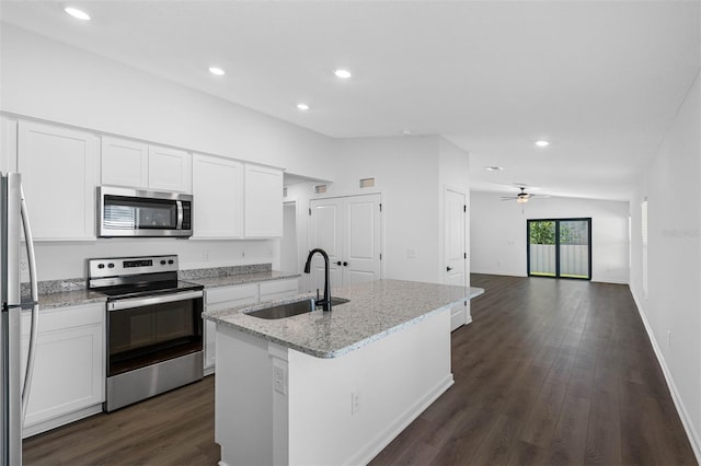 9471 Eldridge Rd, Spring Hill, FL 34608 - kitchen with appliances with stainless steel finishes, a sink, dark wood-style flooring, white cabinetry, and light stone counters