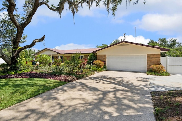 708 Westwood Cir, Brandon, FL 33511 - ranch-style home featuring driveway, an attached garage, and a gate