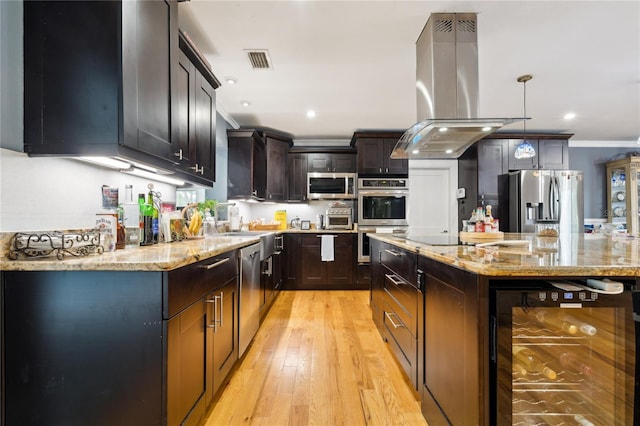 708 Westwood Cir, Brandon, FL 33511 - kitchen featuring wine cooler, island exhaust hood, crown molding, stainless steel appliances, and light stone counters