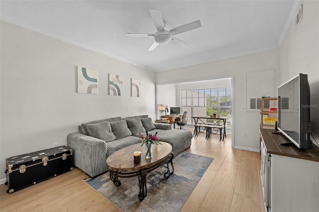 800 S Dakota Ave Unit 337, Tampa, FL 33606 - living area with ornamental molding, a ceiling fan, light wood finished floors, a textured ceiling, and baseboards