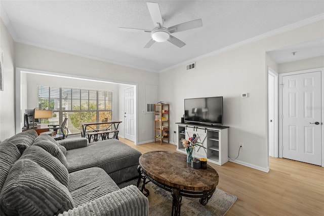 800 S Dakota Ave Unit 337, Tampa, FL 33606 - living area featuring ornamental molding, light wood-type flooring, a ceiling fan, baseboards, and a textured ceiling