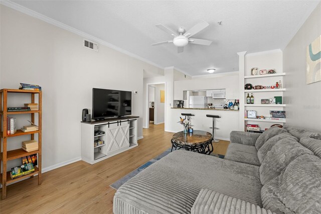 800 S Dakota Ave Unit 337, Tampa, FL 33606 - living room with a ceiling fan, light wood-style floors, ornamental molding, and baseboards