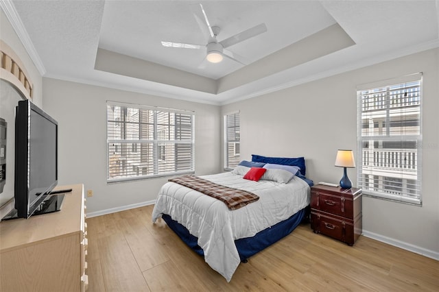 800 S Dakota Ave Unit 337, Tampa, FL 33606 - bedroom with a raised ceiling, multiple windows, light wood-type flooring, baseboards, and crown molding