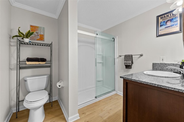 800 S Dakota Ave Unit 337, Tampa, FL 33606 - bathroom with wood finished floors, a shower stall, toilet, crown molding, and vanity