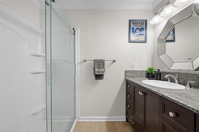 800 S Dakota Ave Unit 337, Tampa, FL 33606 - bathroom with vanity, a shower stall, wood finished floors, baseboards, and crown molding