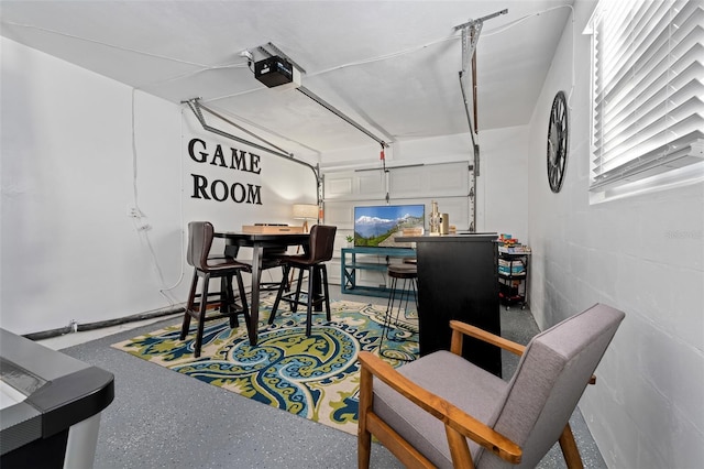 3485 Floral Dr, Largo, FL 33771 - garage featuring a garage door opener and concrete block wall