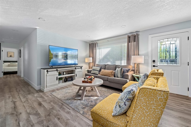 3485 Floral Dr, Largo, FL 33771 - living room with light wood-type flooring and a textured ceiling