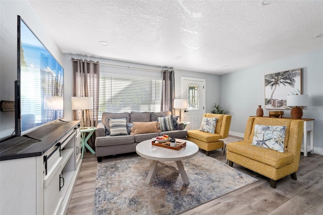 3485 Floral Dr, Largo, FL 33771 - living room featuring a textured ceiling and light wood-type flooring