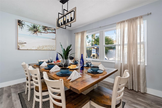 3485 Floral Dr, Largo, FL 33771 - dining area with wood finished floors and a chandelier