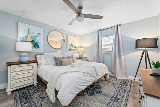 3485 Floral Dr, Largo, FL 33771 - bedroom featuring wood finished floors, a textured ceiling, and ceiling fan
