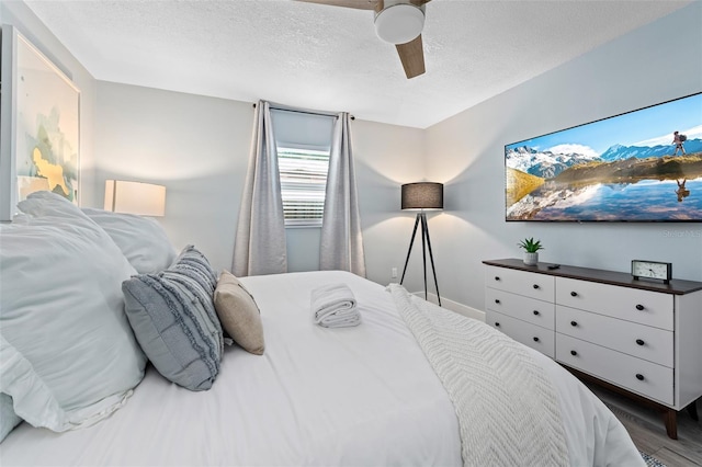 3485 Floral Dr, Largo, FL 33771 - bedroom featuring a textured ceiling, a ceiling fan, and wood finished floors