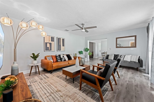 3485 Floral Dr, Largo, FL 33771 - living area featuring wood finished floors, a ceiling fan, and a textured ceiling